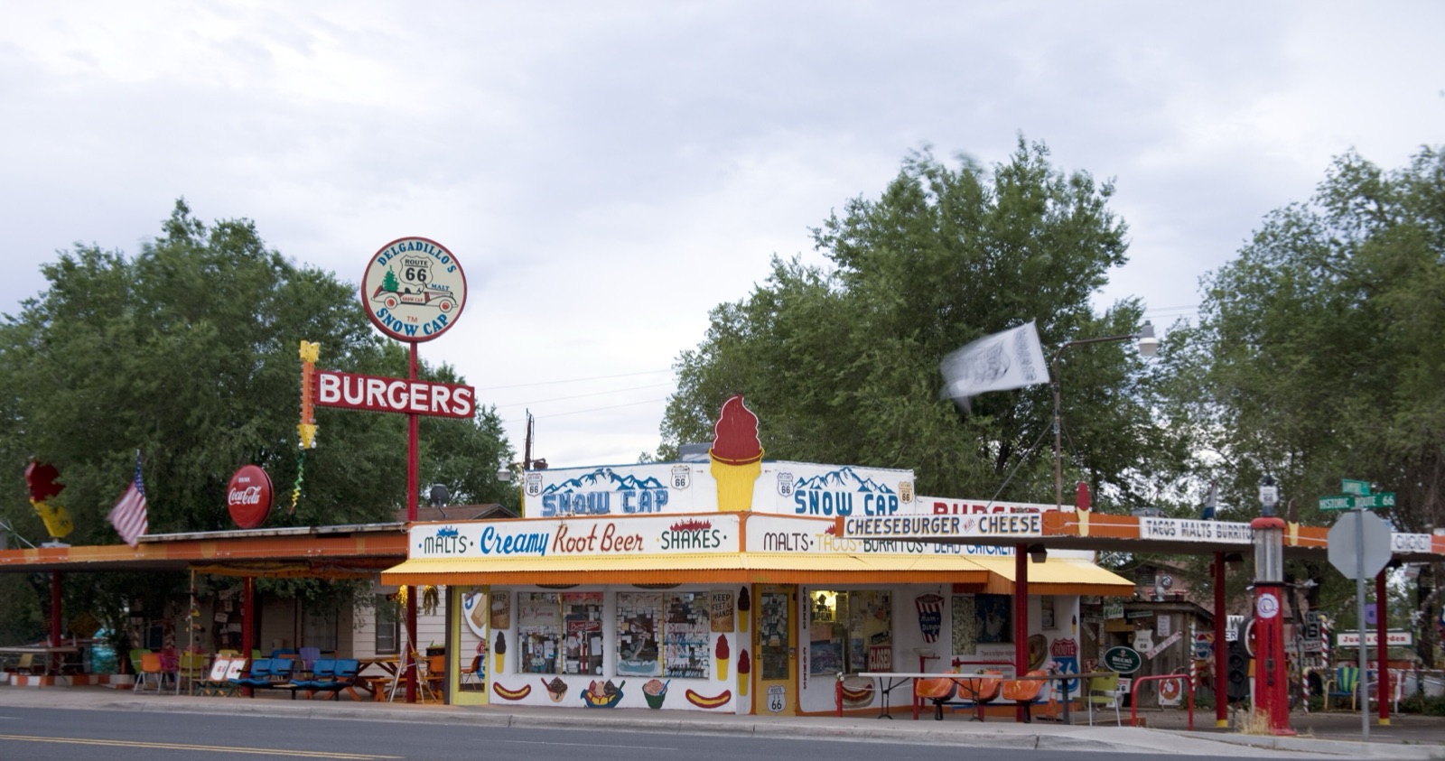 Delgadillo's Snow Cap drive-in in Seligman, Arizona, with its painted sign, picnic tables and vintage cars
