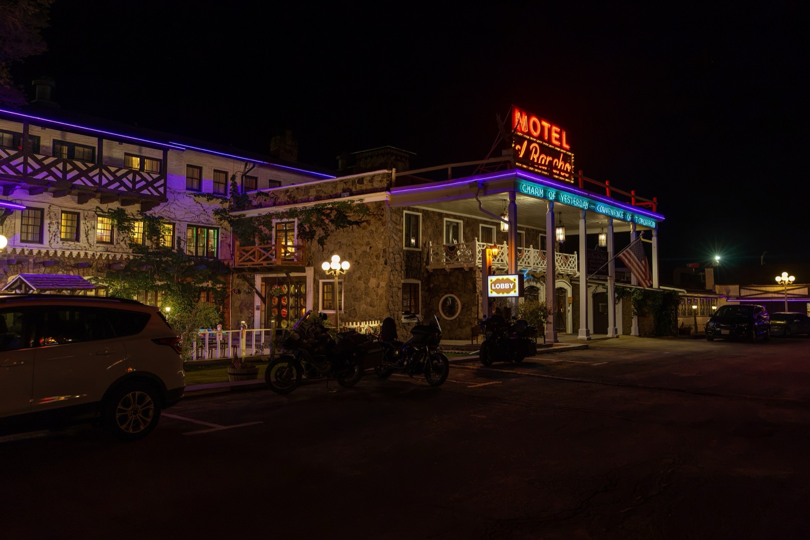 Hotel El Rancho in Gallup, New Mexico, at night with its red Motel El Rancho neon sign and lit balconies