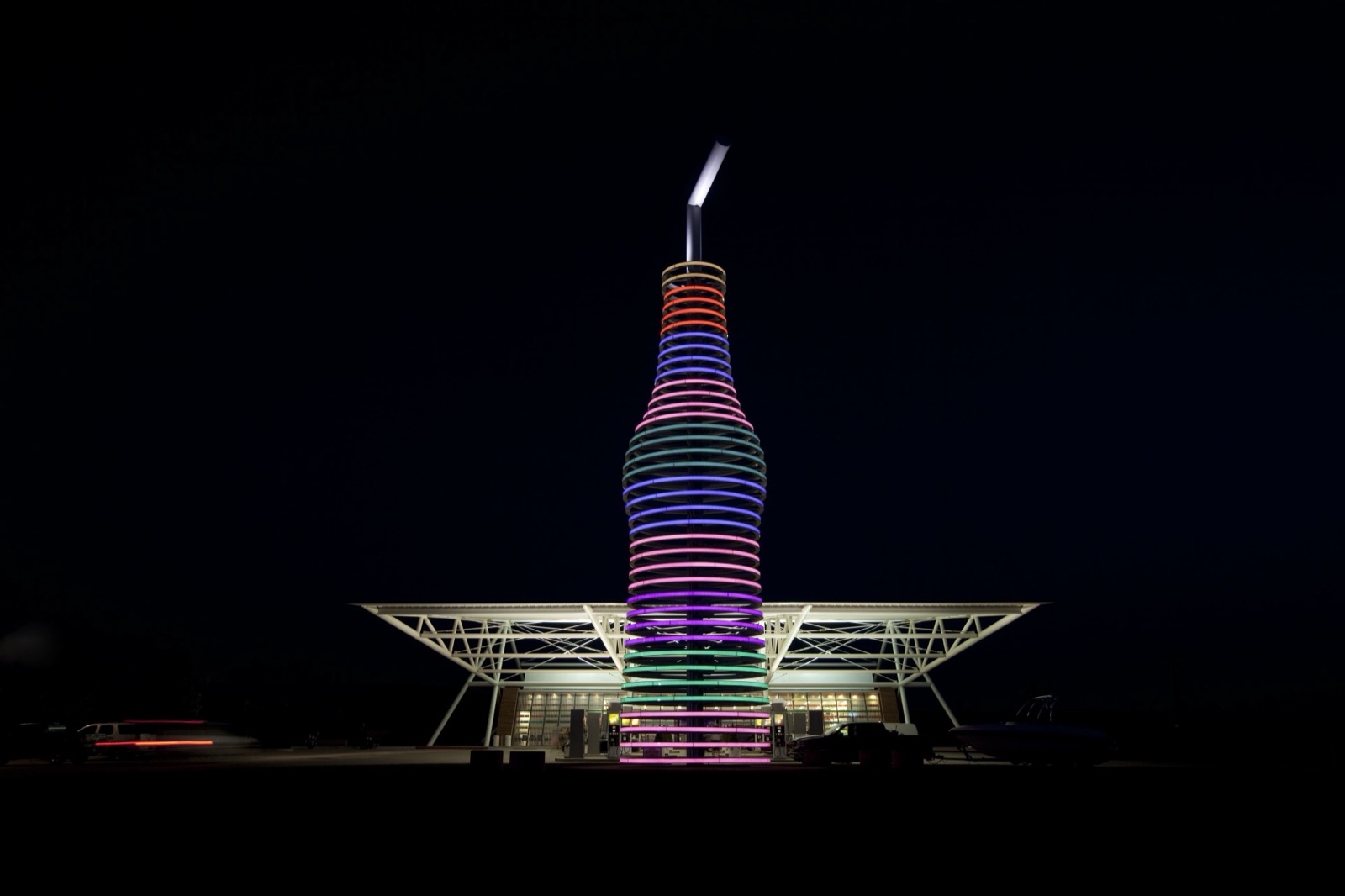 The 66-foot soda bottle sign at POPS in Arcadia, Oklahoma, lit in rings of colored light at night